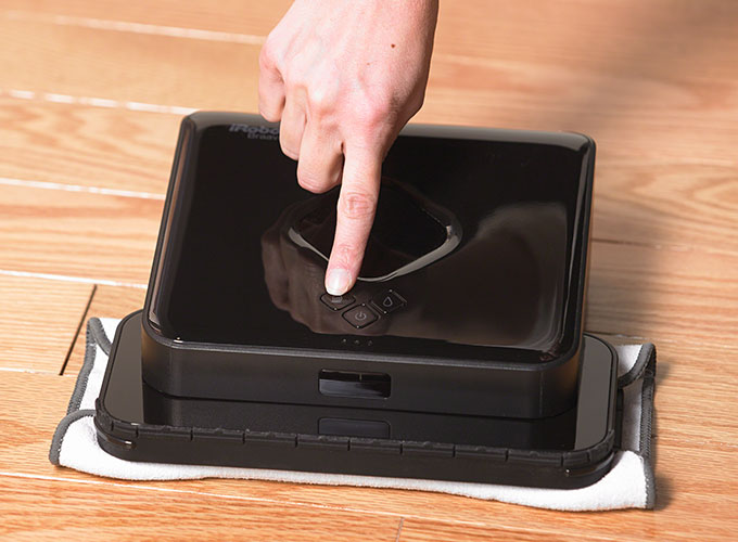 Attach a cleaning cloth and press Mop or Sweep.