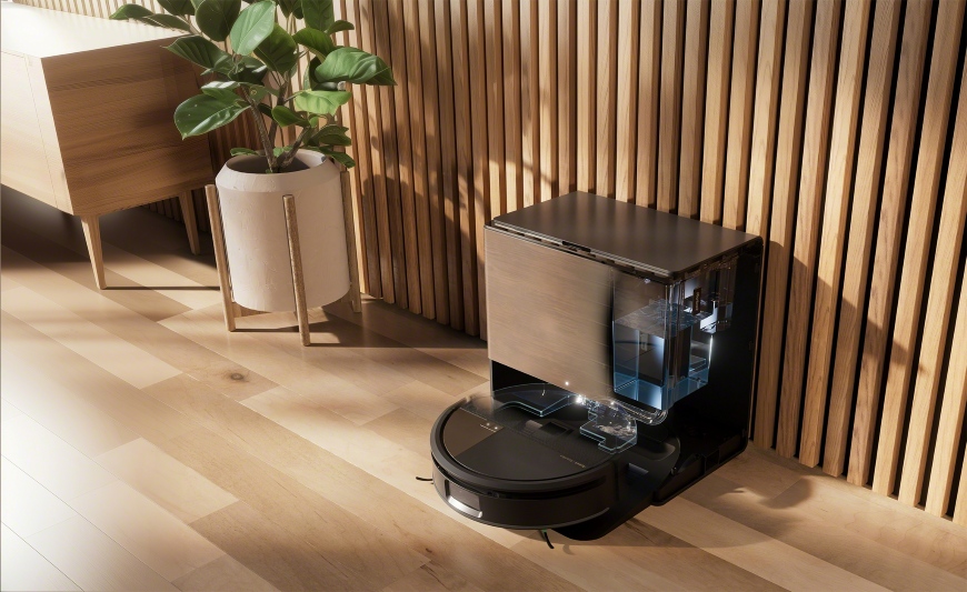 Robot Roomba Max 705 Combo w stacji AutoWash stoi pod ścianą ozdobioną lamelami, obok szafka RTV i kwiat doniczkowy
