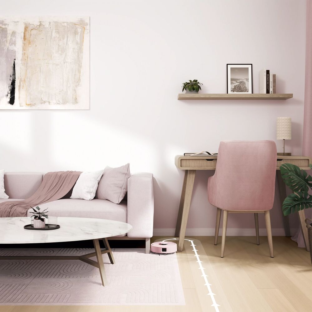 Roomba Mini sprząta w równych liniach w salonie obok sofy i biurka z krzesłem
