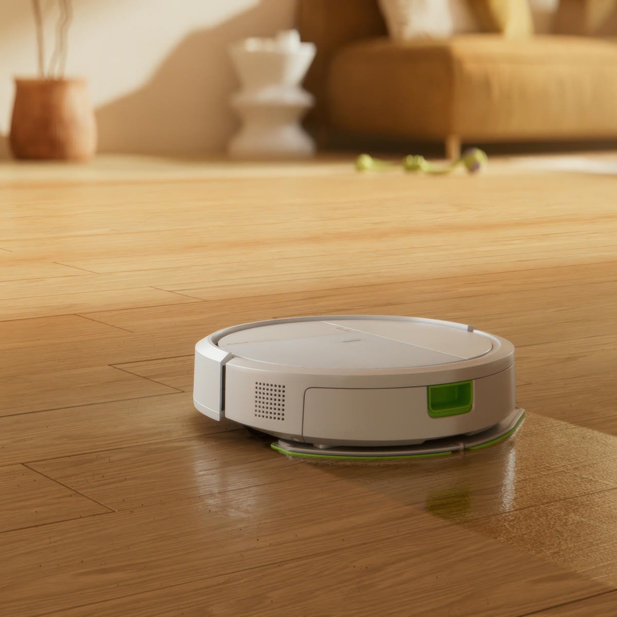 Roomba 115 Combo odkurza i&nbsp;mopuje panele w&nbsp;salonie, na drugim planie sofa i&nbsp;inne dekoracje