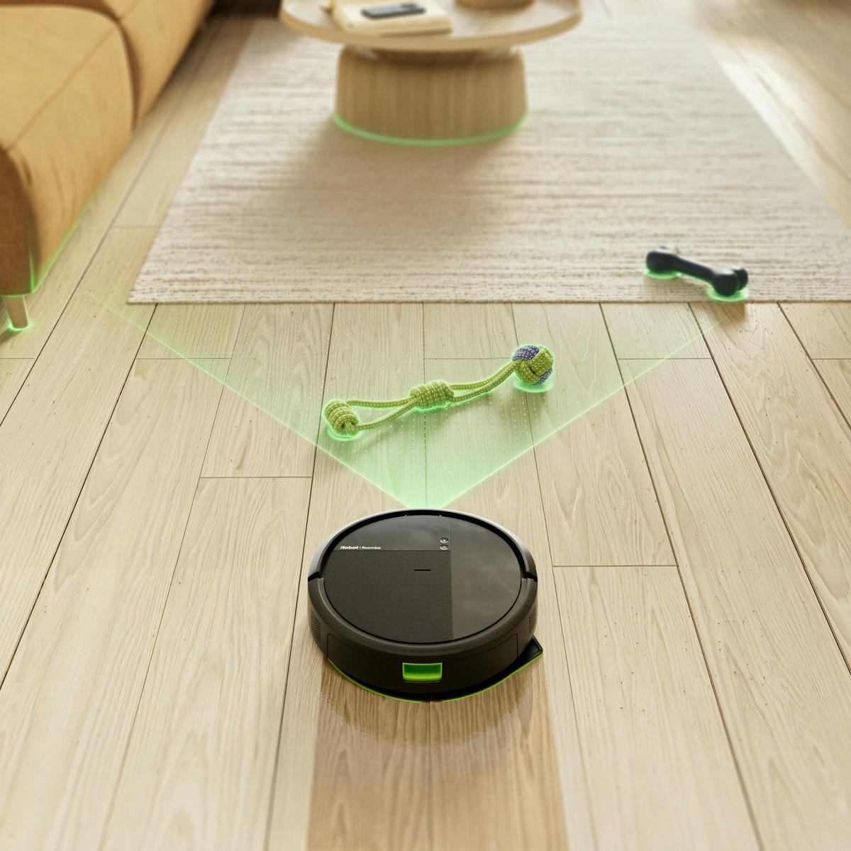 Robot Roomba sprząta panele w&nbsp;salonie wykrywając psie zabawki na swojej drodze